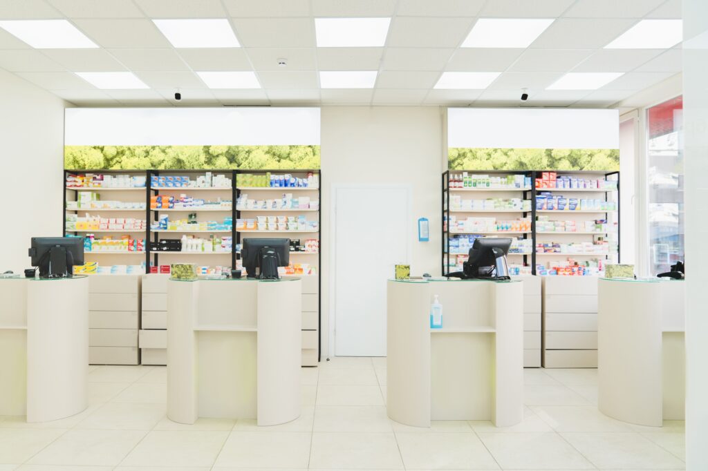 Four empty without visitors clients staff cash point desks at pharmacy drugstore chemist`s store